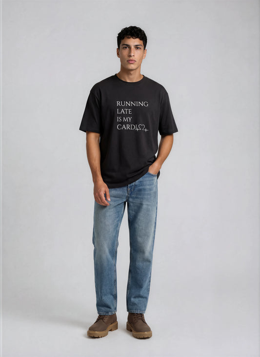 Person wearing a black t-shirt with text and blue jeans on a white background