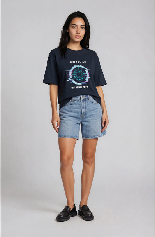 Person wearing a black t-shirt with text and graphics on a plain background