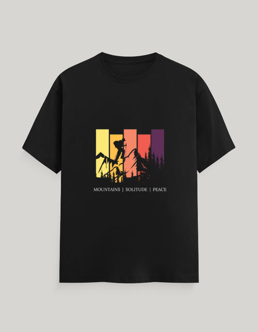 Black t-shirt with colorful graphic design on a gray background