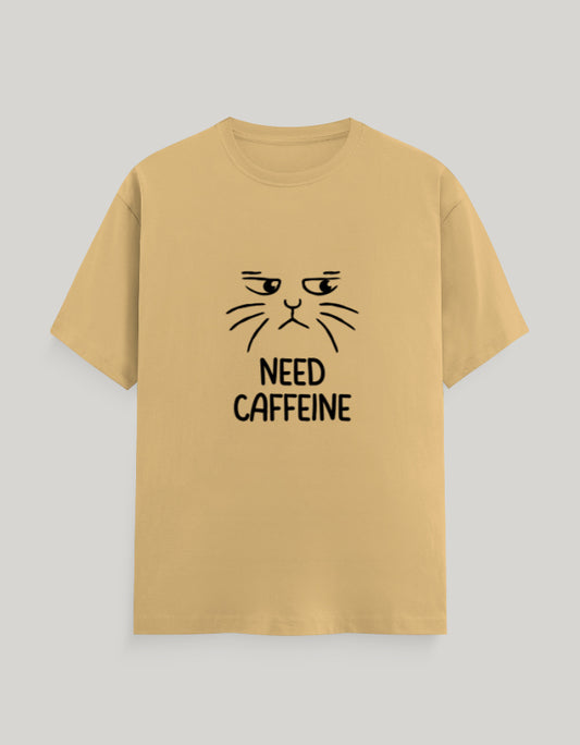 Beige t-shirt with a cat face graphic and 'NEED CAFFEINE' text on a light gray background